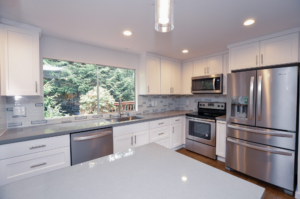 Modern kitchen with pendant lighting above a large island and open-concept layout.